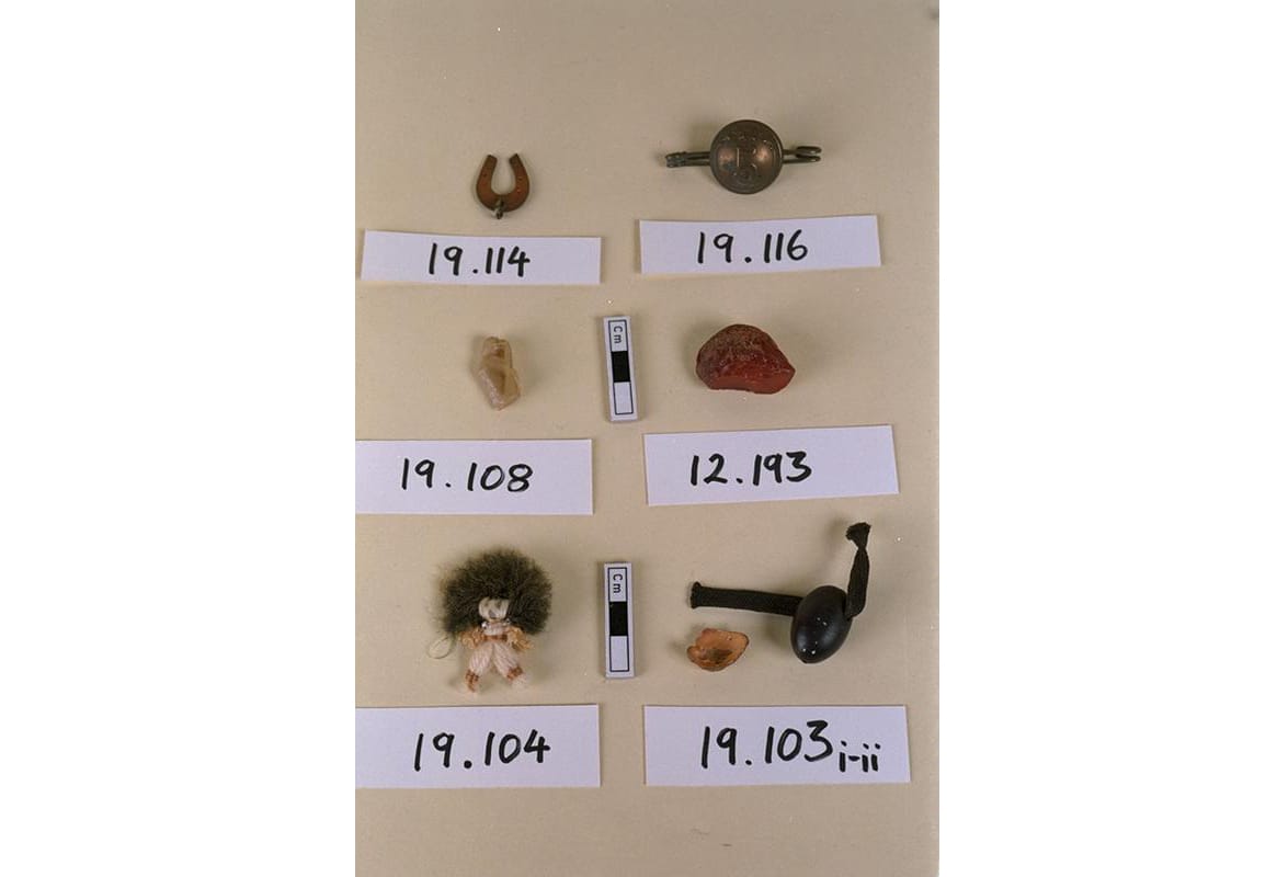 Assorted charms including small horse shoe on a brown background