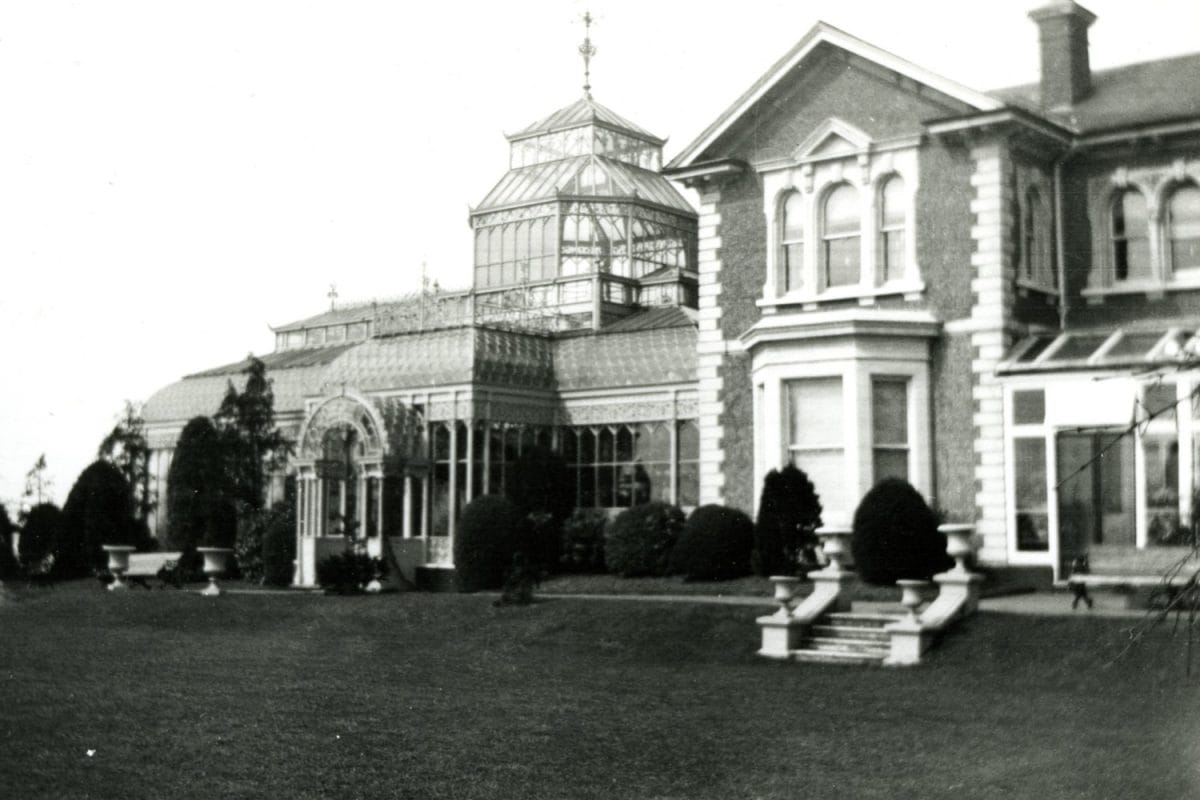 A large house with conservatory at the side.