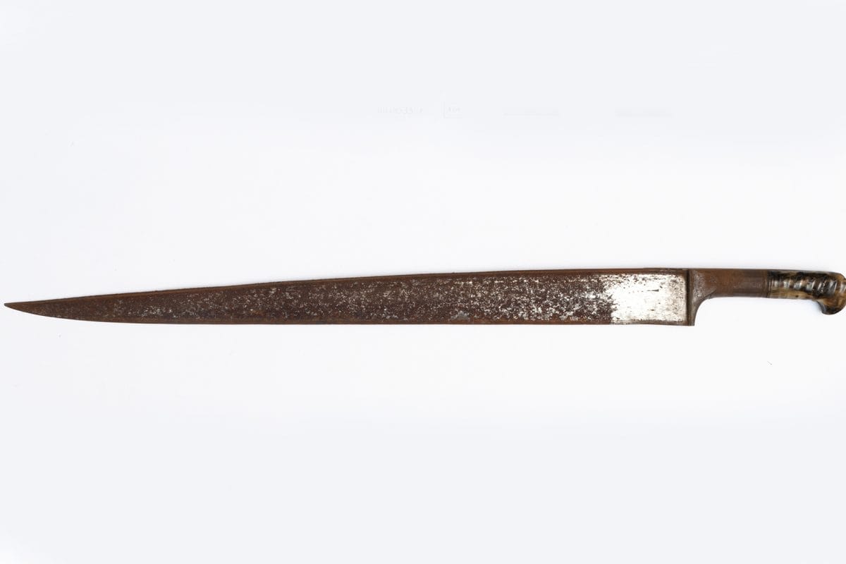 thin rusted knife on white background.