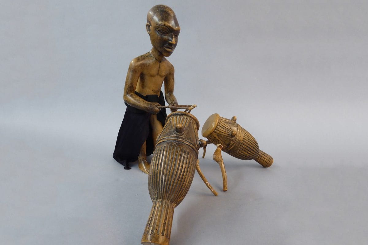 Figure of a man playing drums.