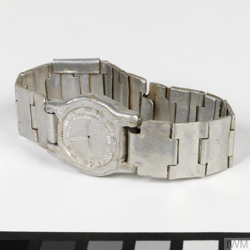 Silver bracelet shaped like watch.