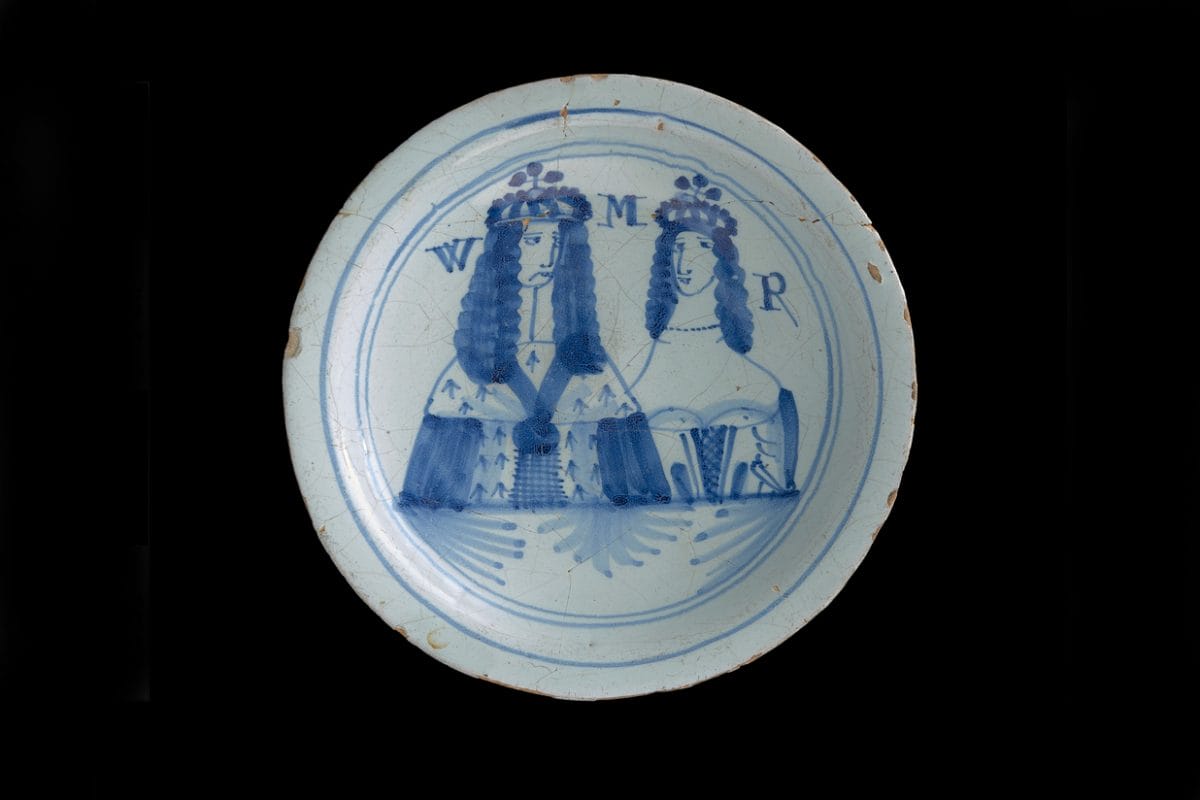 White slightly worn plate with water painting of King and Queen