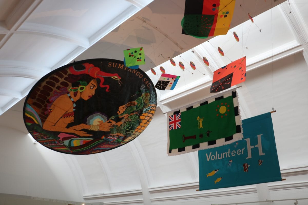 Kites hanging from gallery ceiling.