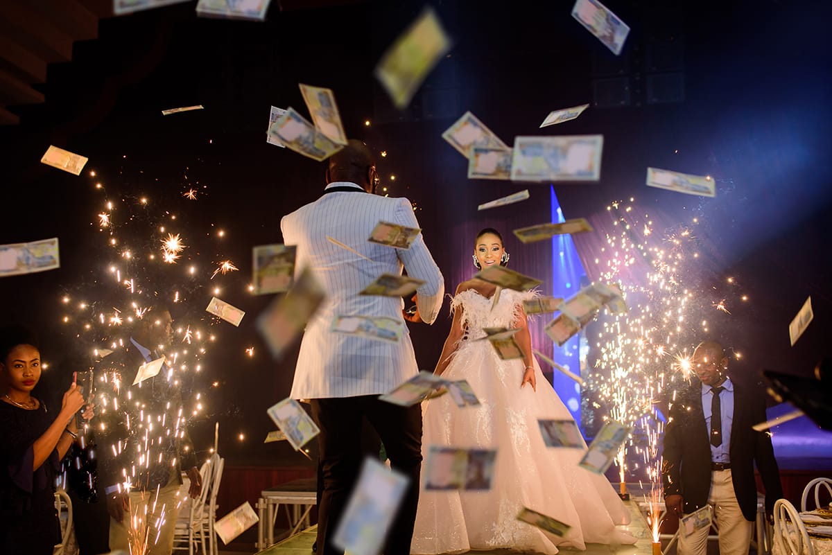 Money falling around a bridge and groom