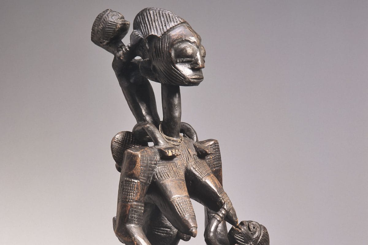 Seated wooden female with children