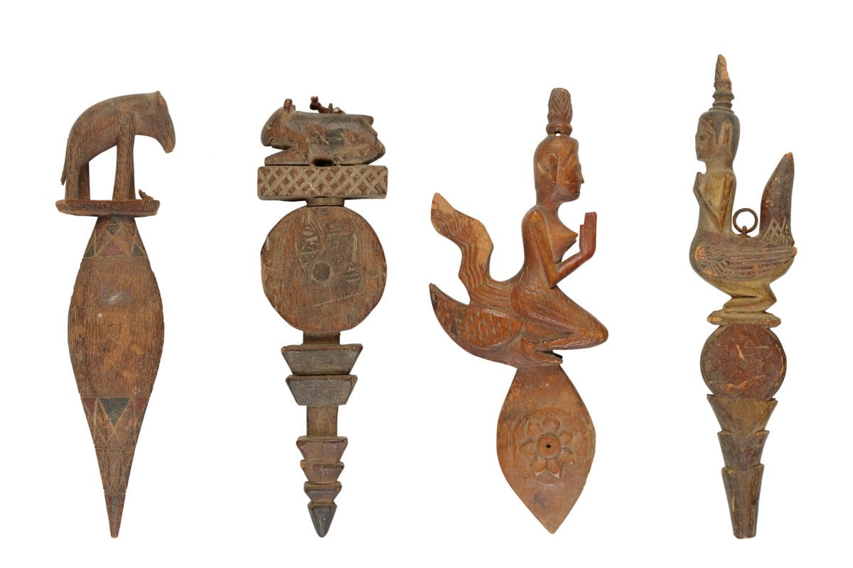 Four wooden figures carved into different shapes.