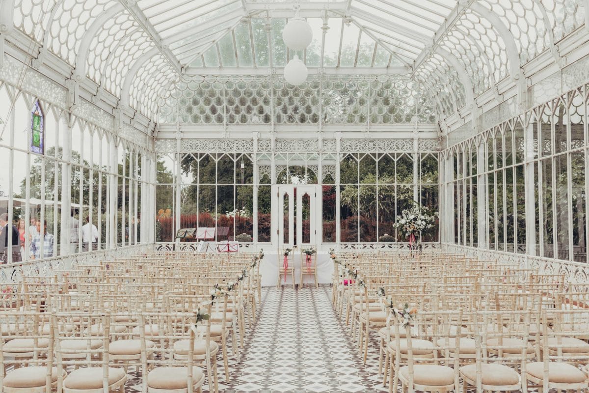 Rows of chairs laid out for wedding ceremony in Horniman Conservatory