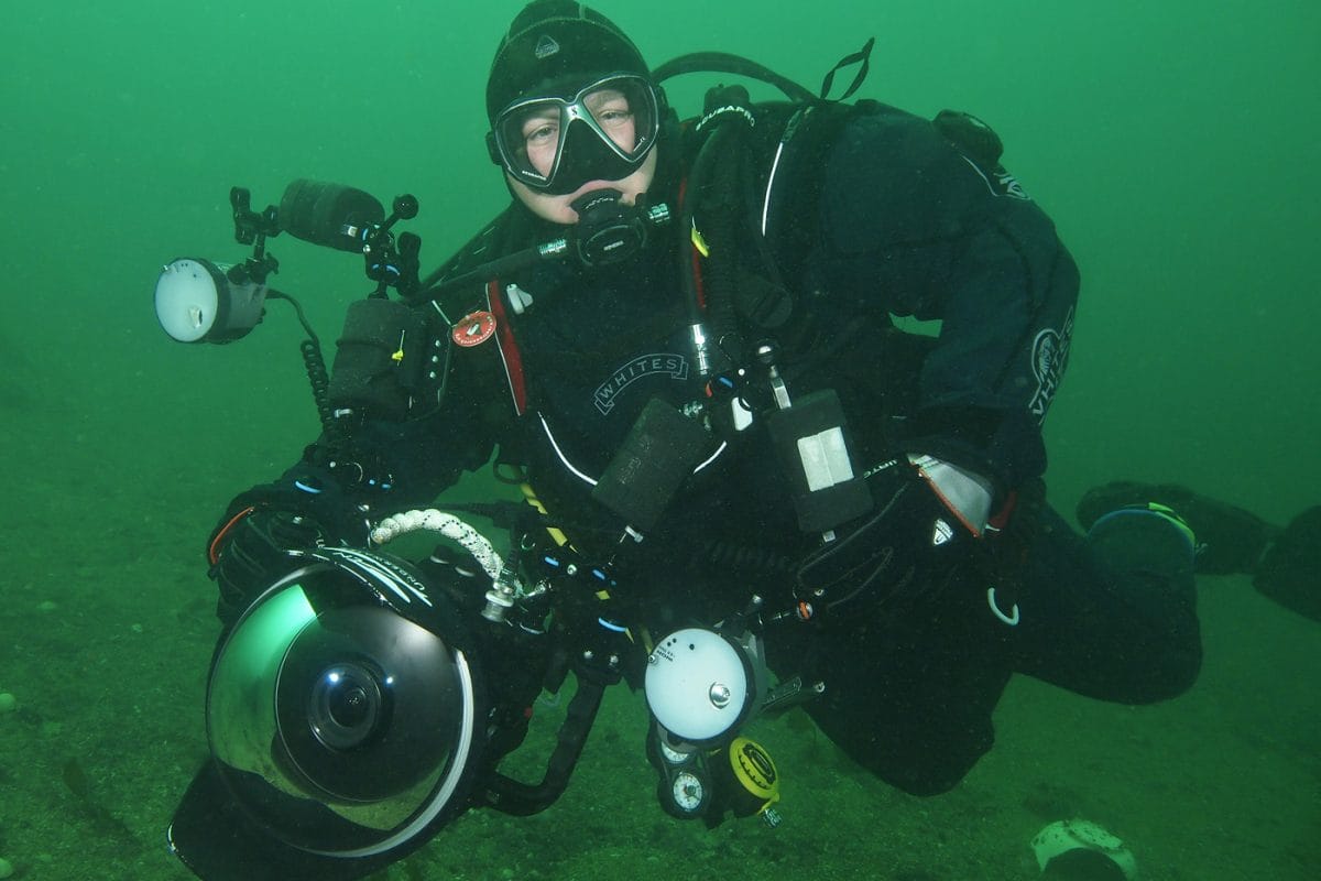 Man in ocean with camera kit