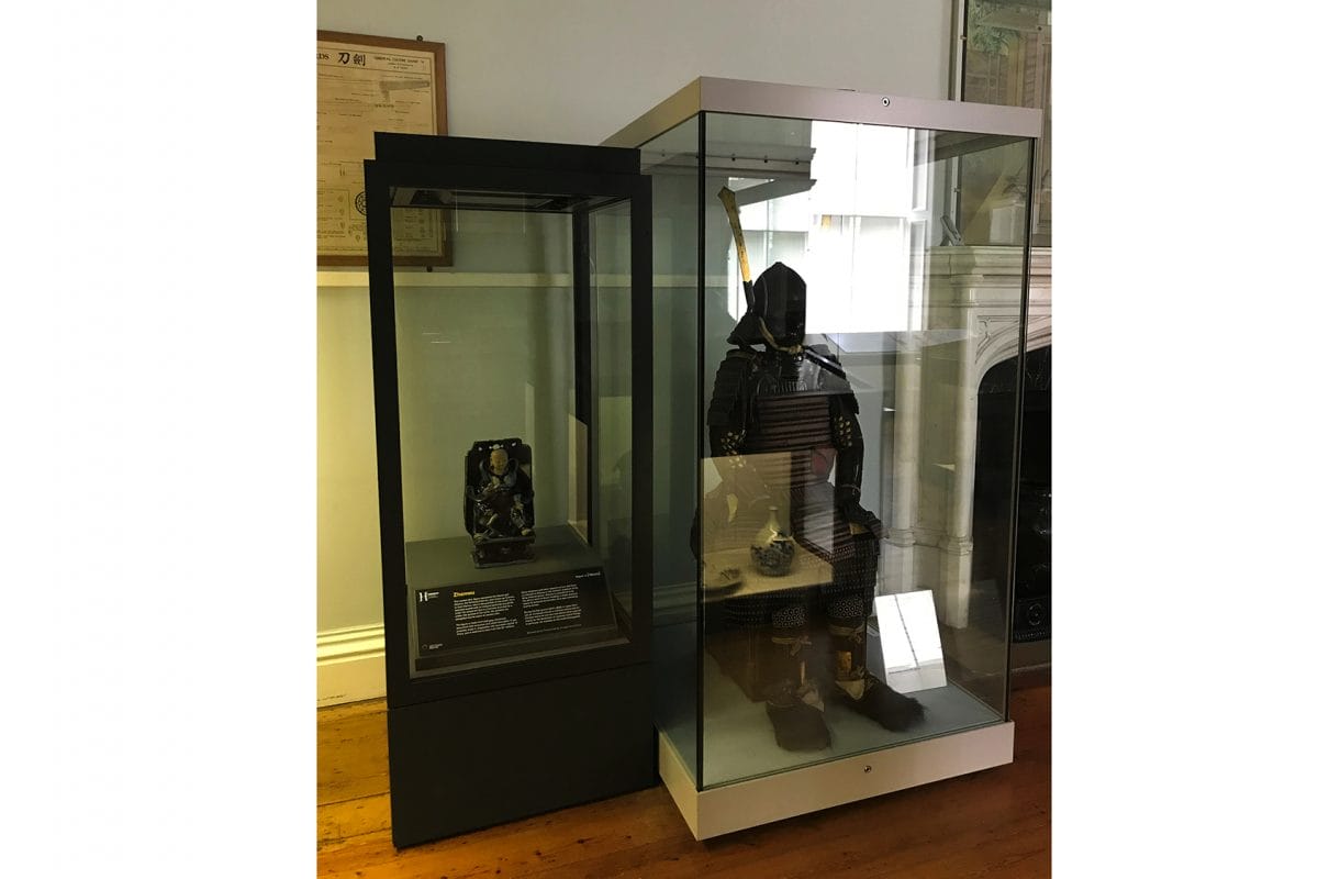 figure on display next to samurai armour