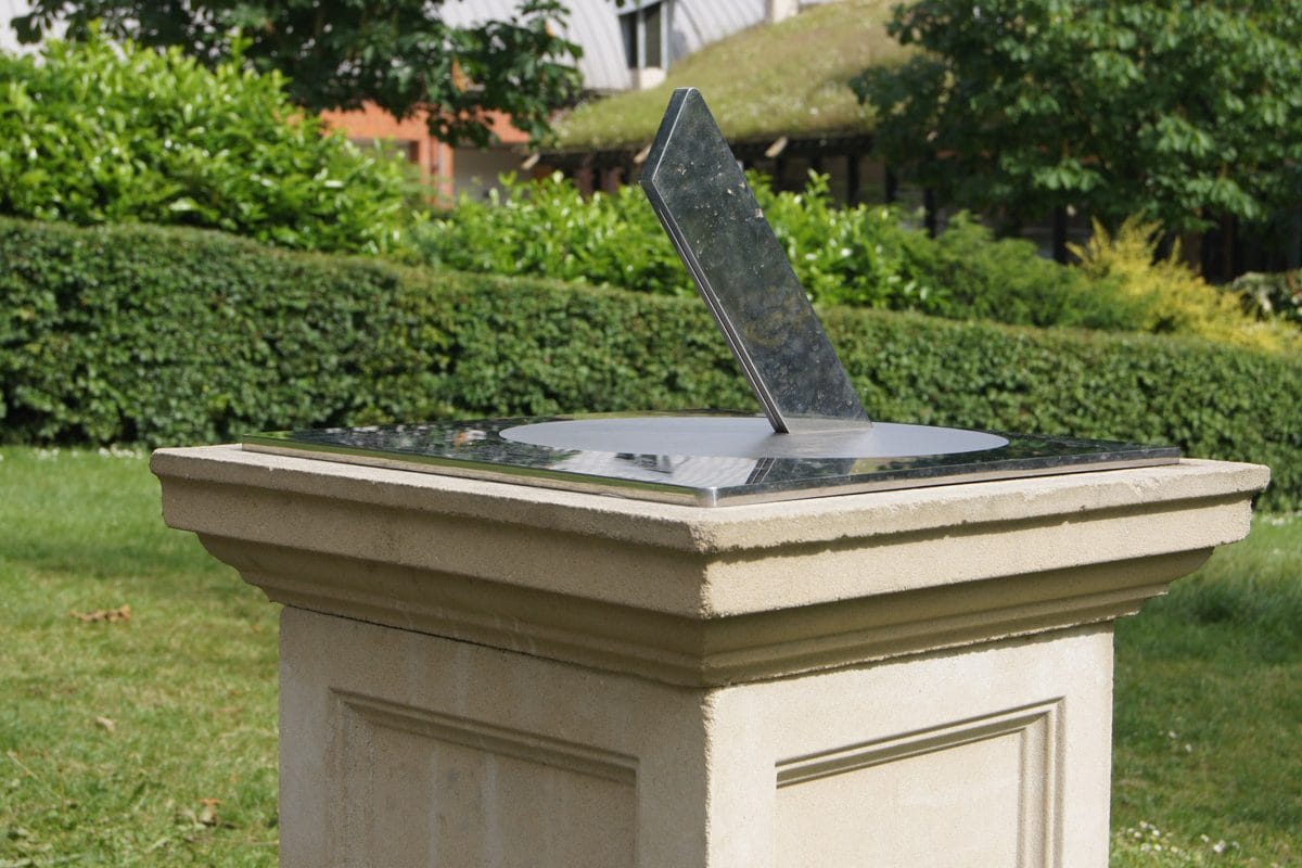 A metal sundial in a garden