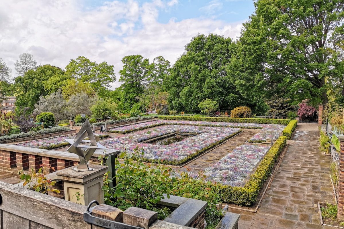 Large square garden with small pond in the centre