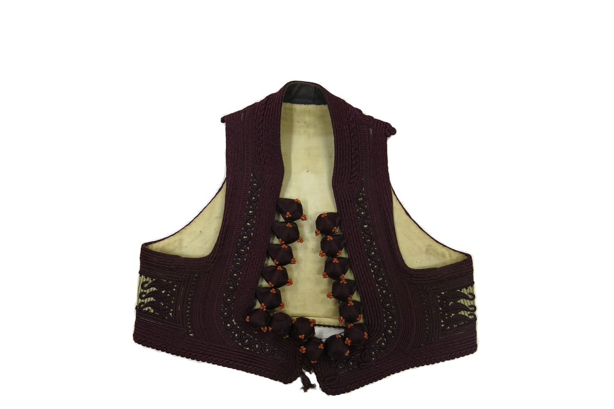 Woman's short sleeveless waistcoat (jelek) of blue and yellow striped silk lined with cream cotton and almost entirely covered with heavy purple embroidery