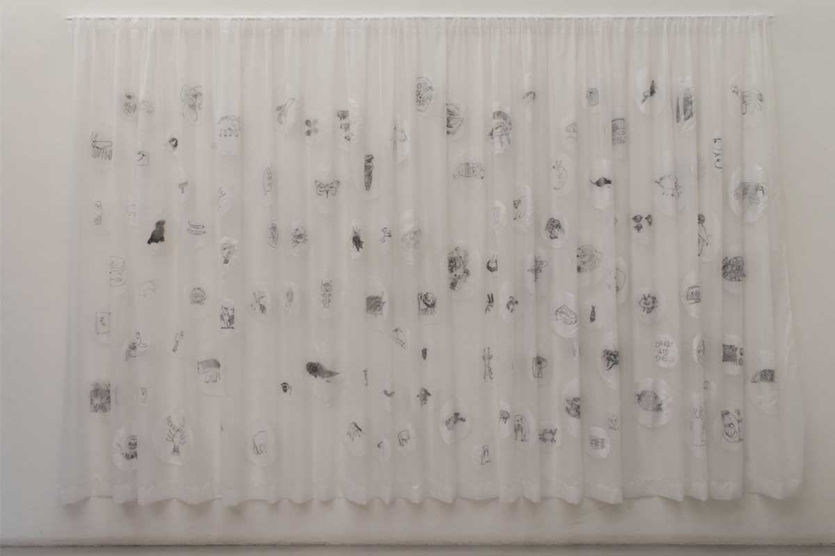 The final net curtain, hung up and covered in the embroidered drawings