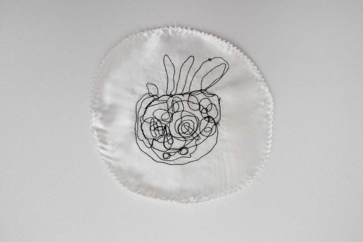 Embroidery of a drawing of a shell