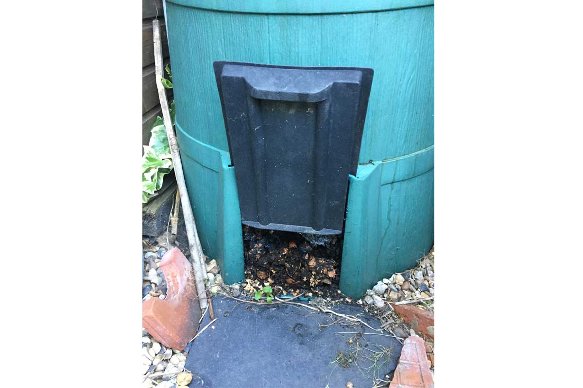 Door at the bottom of a compost bin