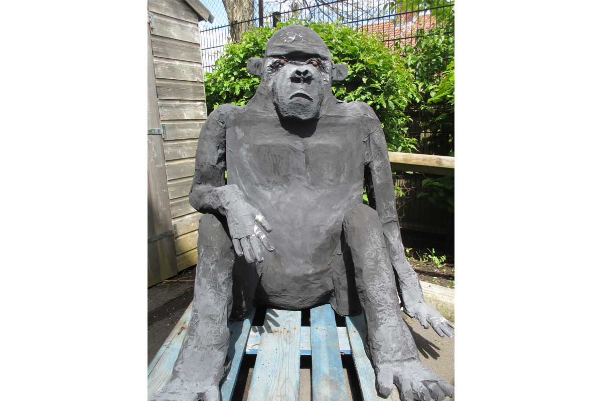 Large papier mache gorilla sat outside