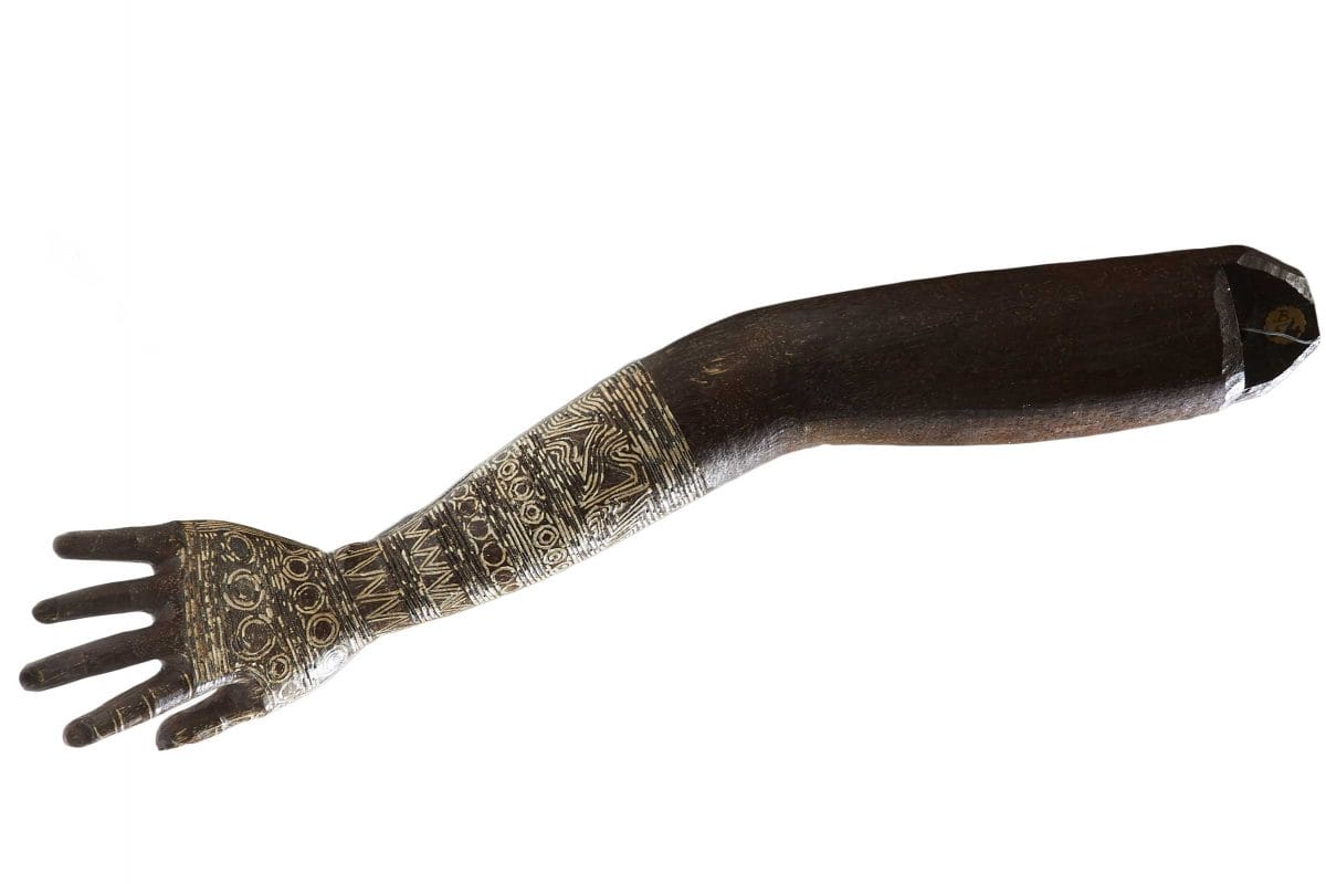 Wooden model of an arm with tattoo on