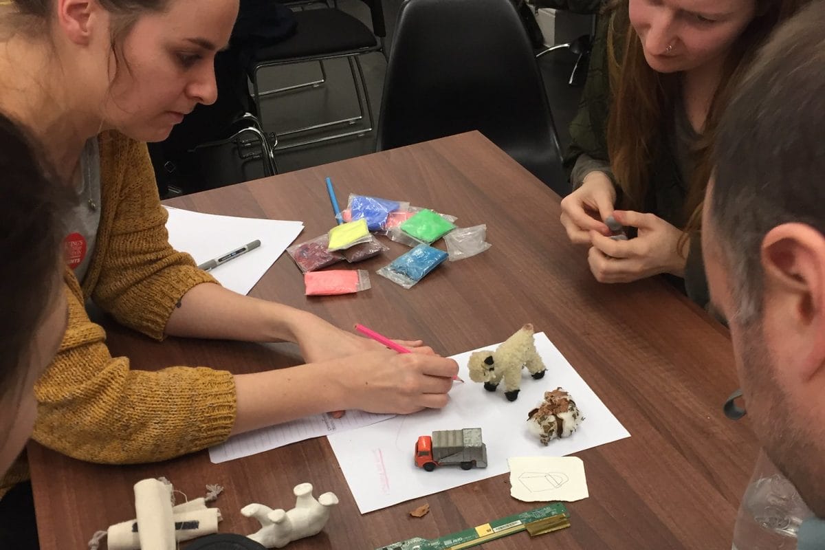 Adults looking at models to illustrate climate change