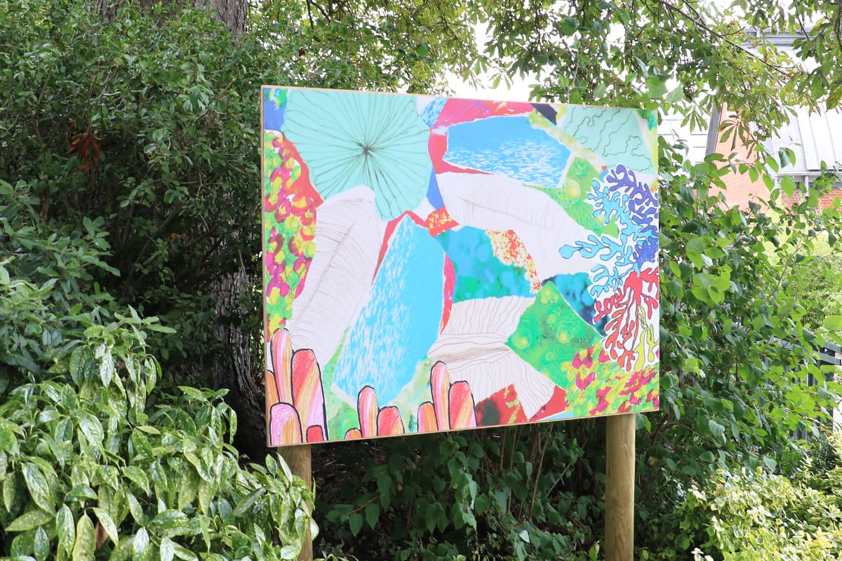 Abstract painting of coral on boards in the gardens