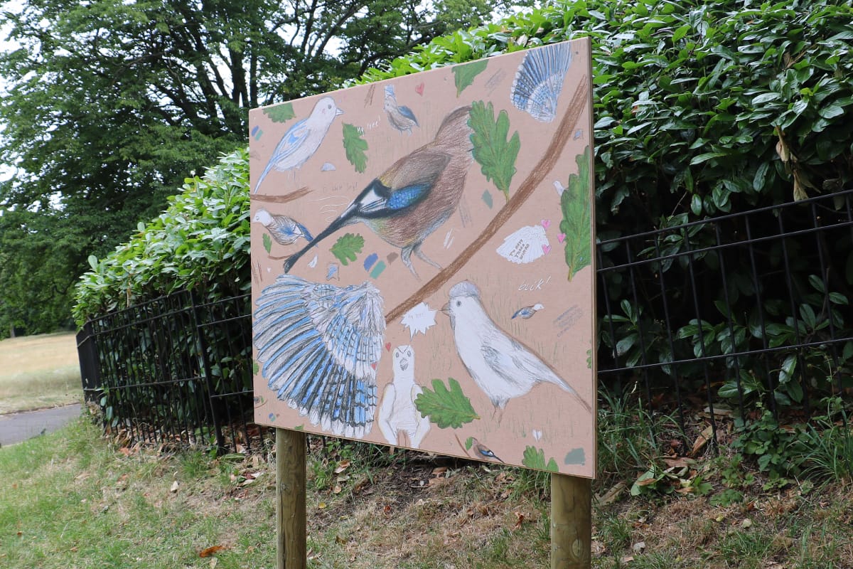 Abstract painting of birds on boards in the gardens