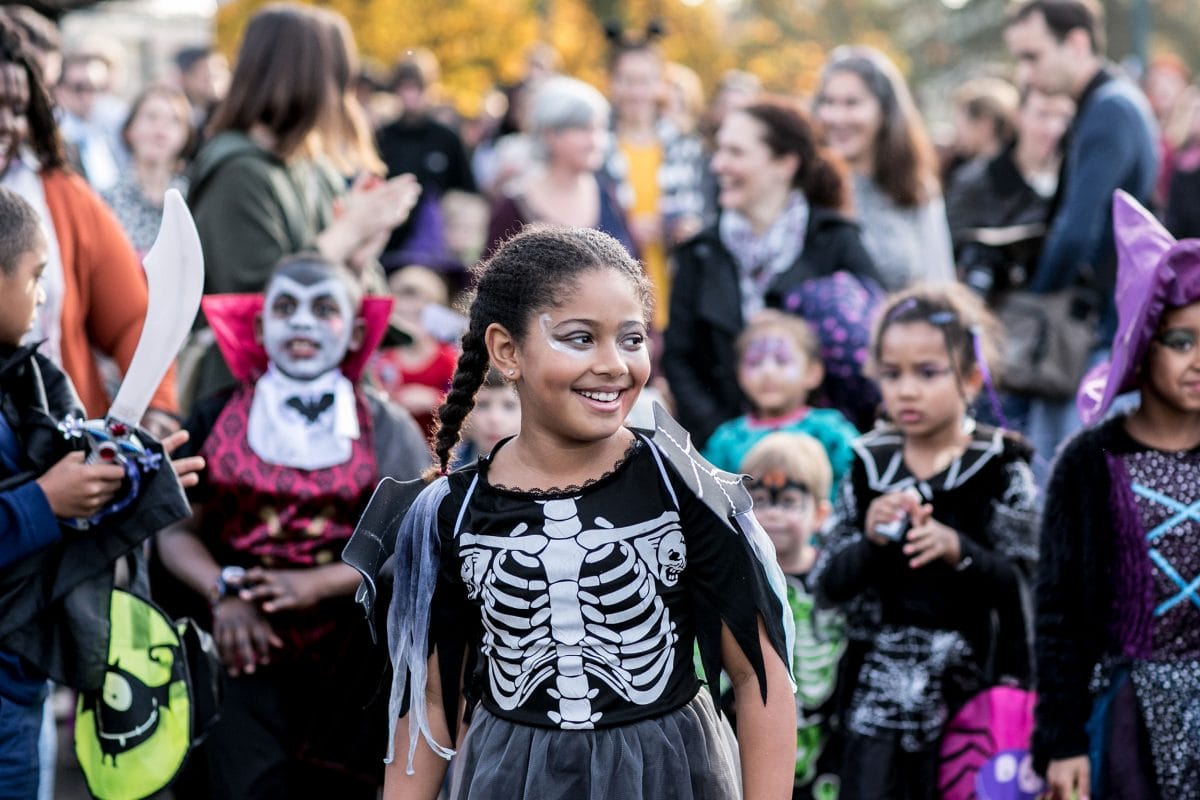 A girl wearing a skeleton outfit at the Halloween Fair