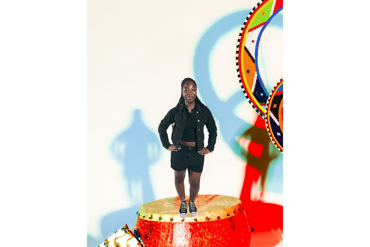 A young woman standing superimposed to be standing on a drum