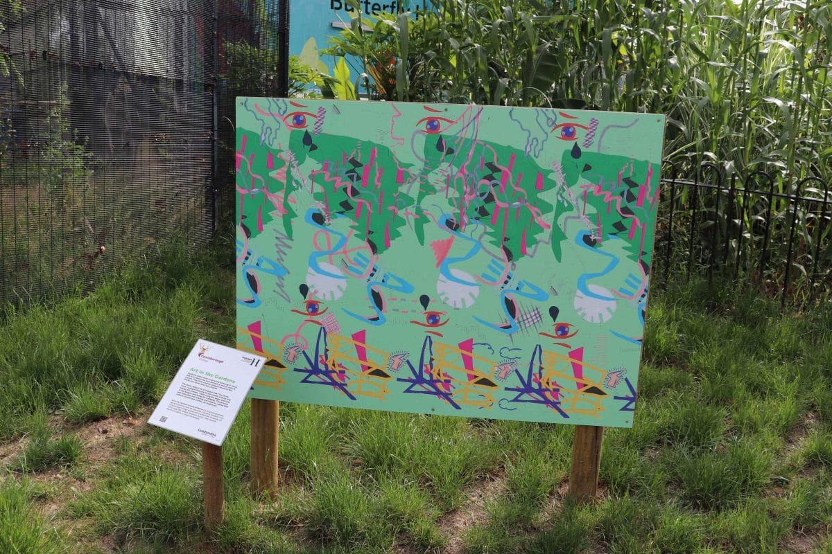 A Horniman garden art board designed by students, with a green background and pink throughout