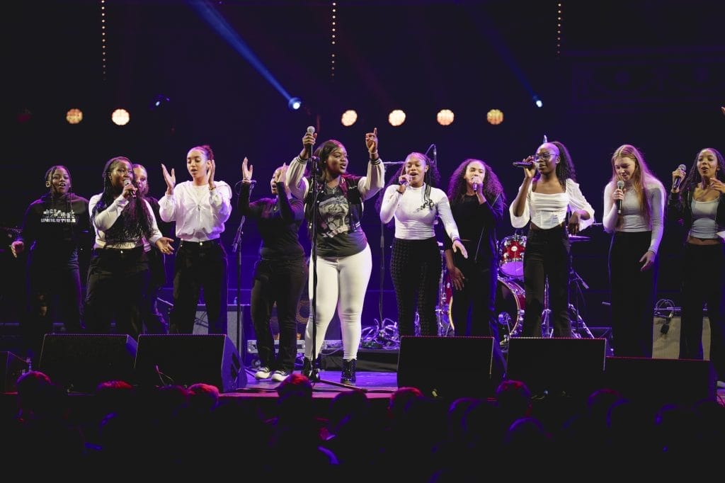 People sing on a stage