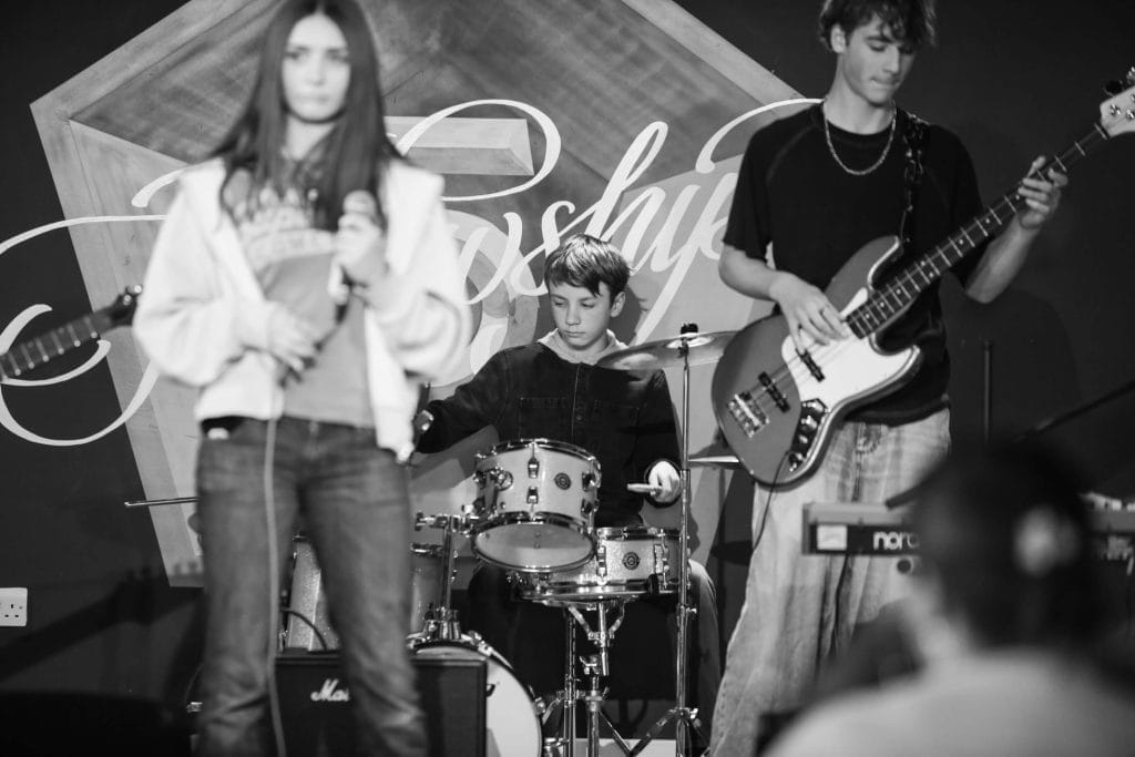 Young people perform music on a stage