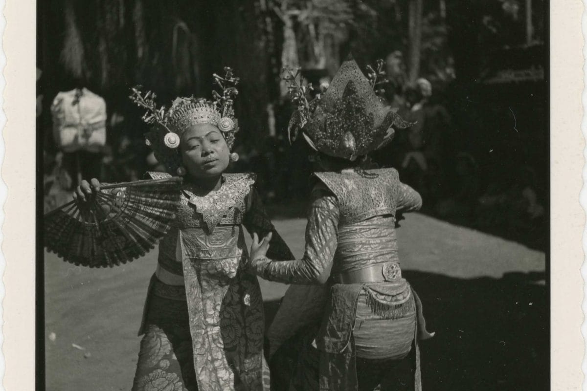 Archive photograph of two people wearing traditional dress and dancing together