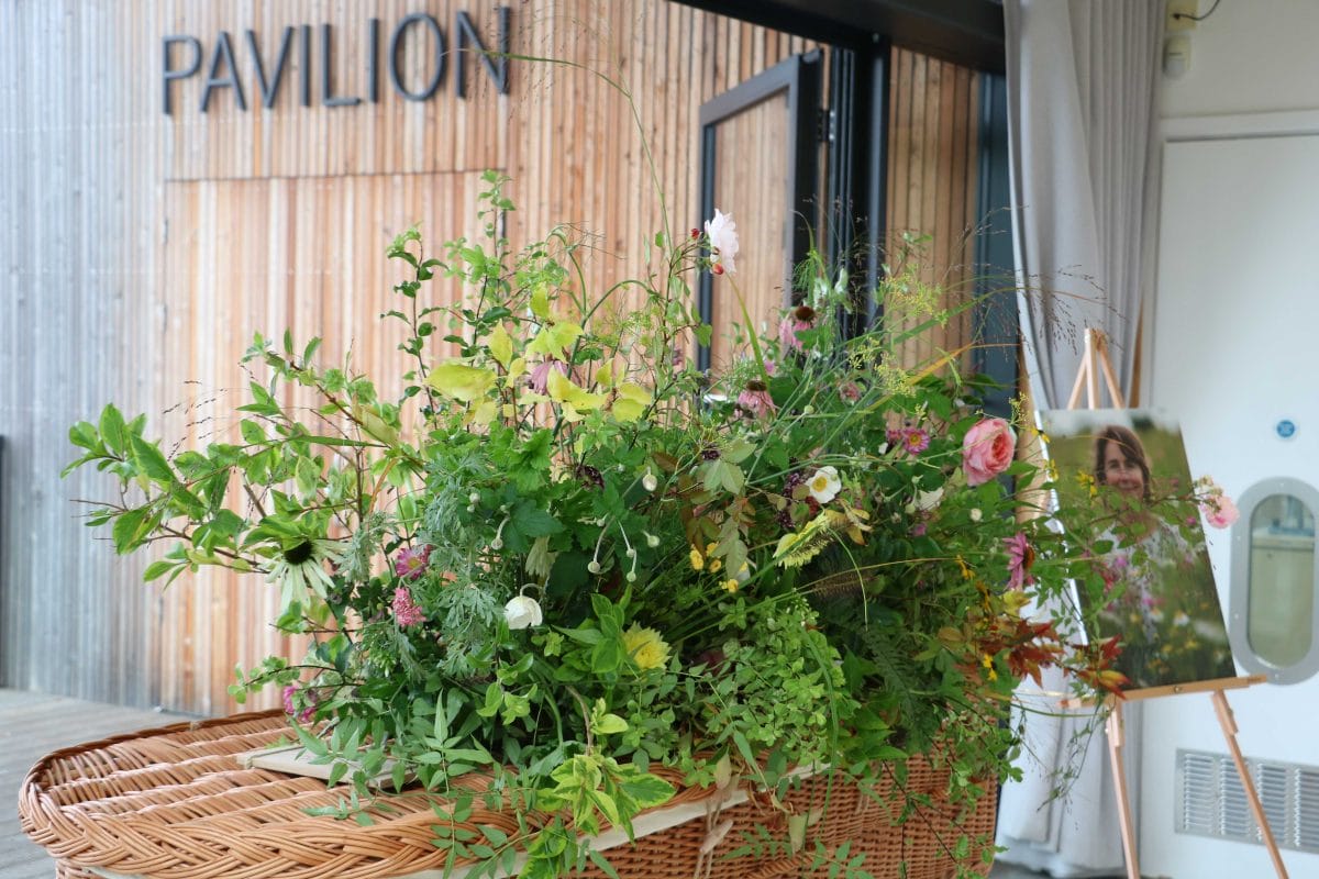 Close up of flower display on wicker coffin