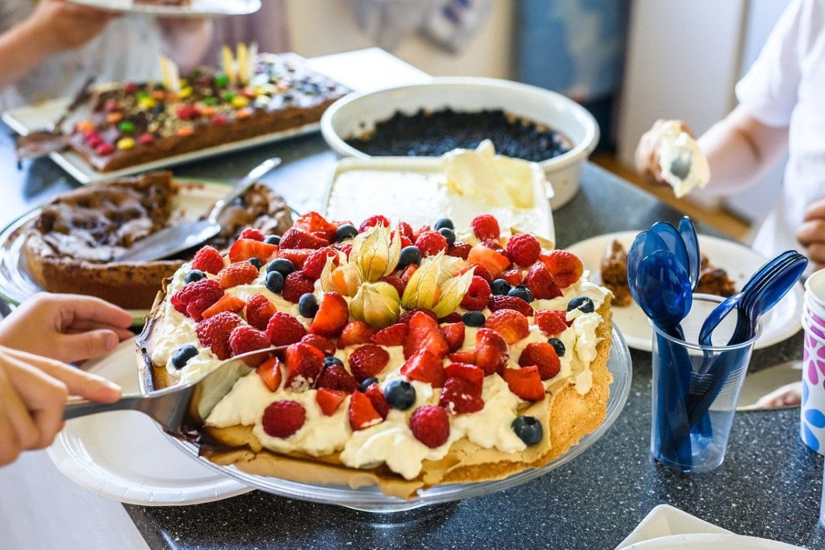 Pavlova topped with summer fruits.