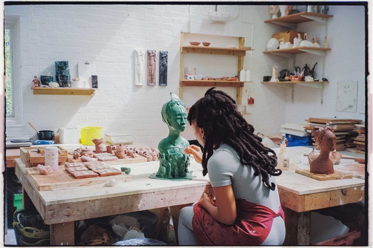 Artist Osaru Obaseki works on a sculpture in a studio