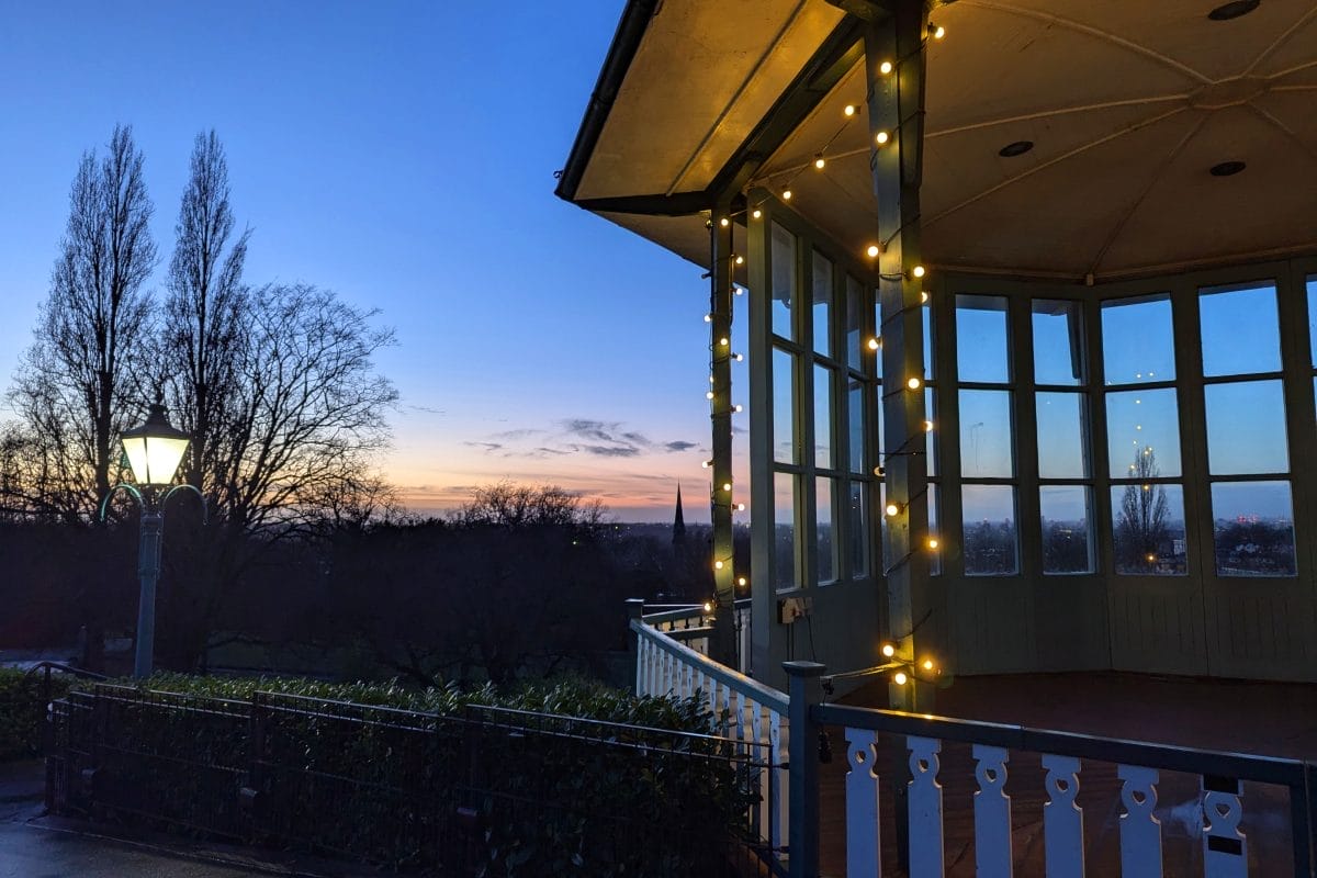 Bandstand at dusk lit with bulb lights