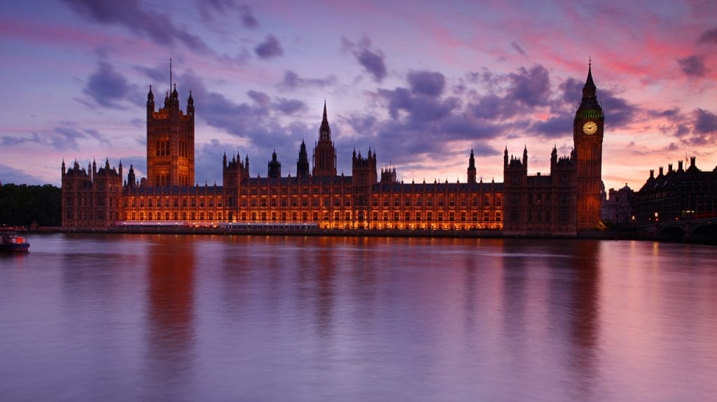 Houses of Parliament at dusk against a pink sky