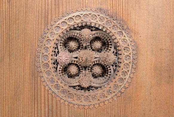 A close of a wooden carving on a musical instrument