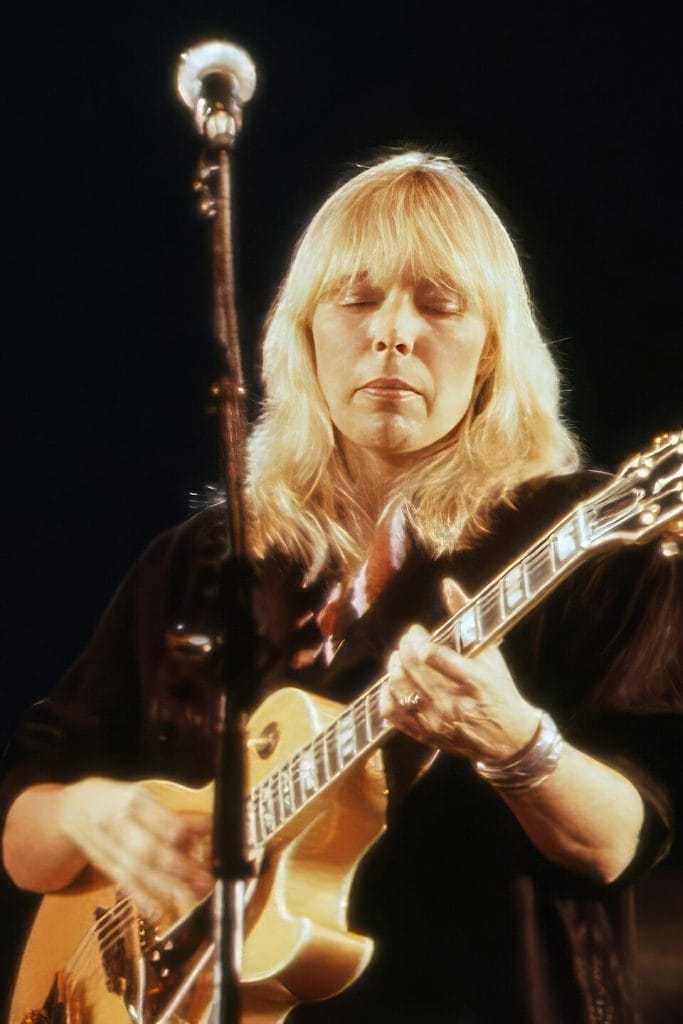 Joni Mitchell playing guitar