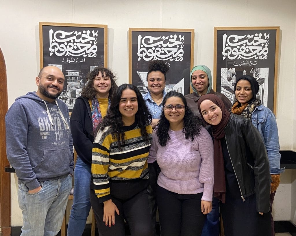 Eight people smiling for a group photo