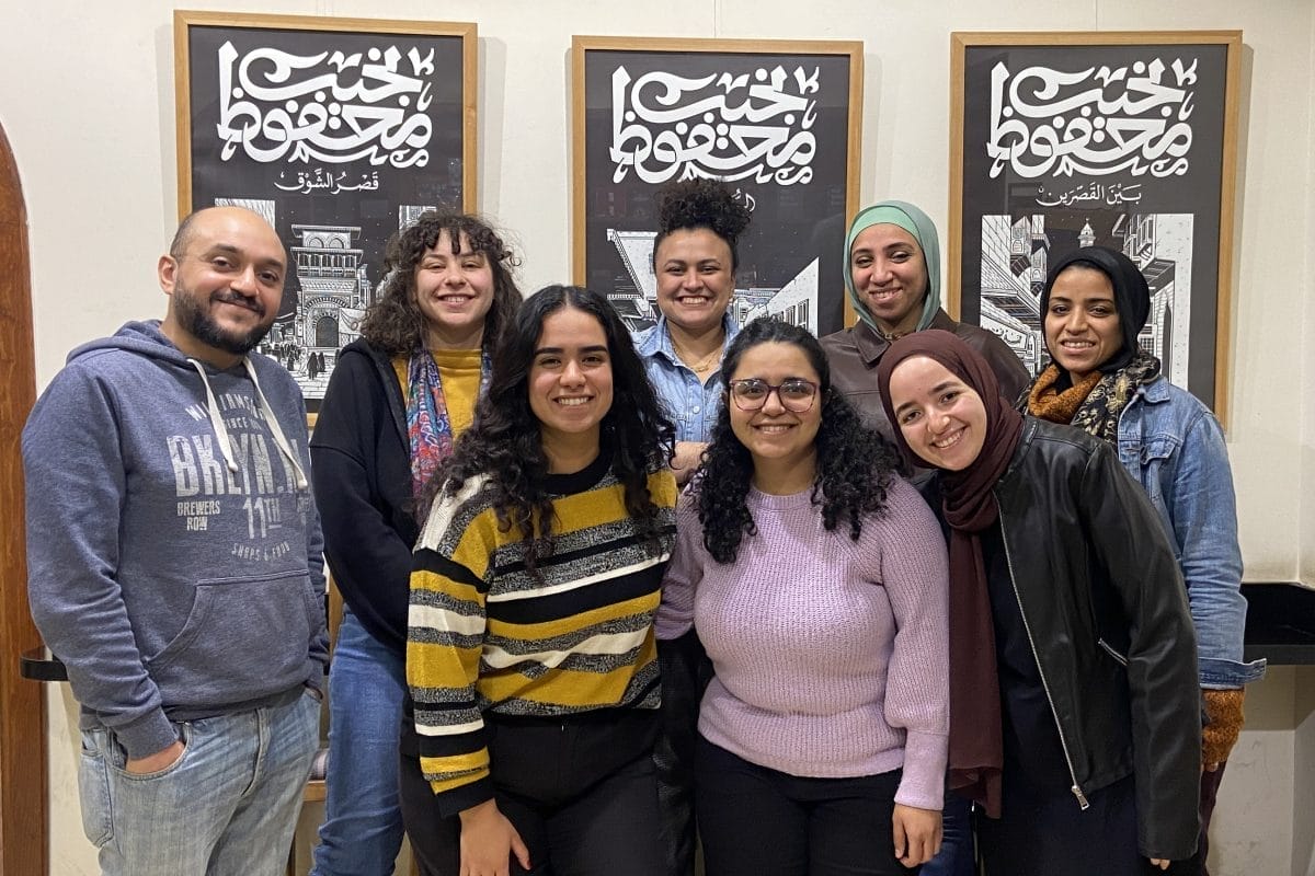Eight people smiling for a group photo