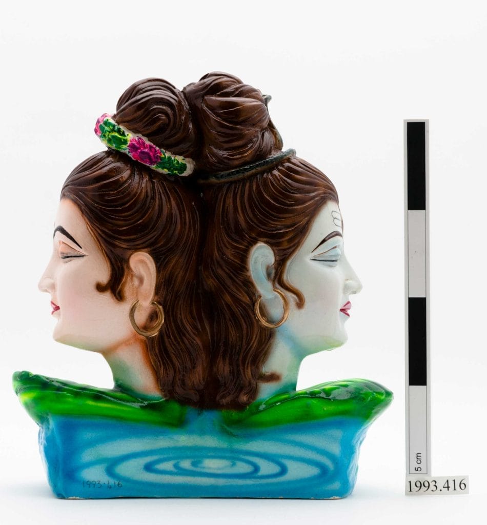 Figurine of Parvati and Shiva's heads, turned away from each other but joined at the back