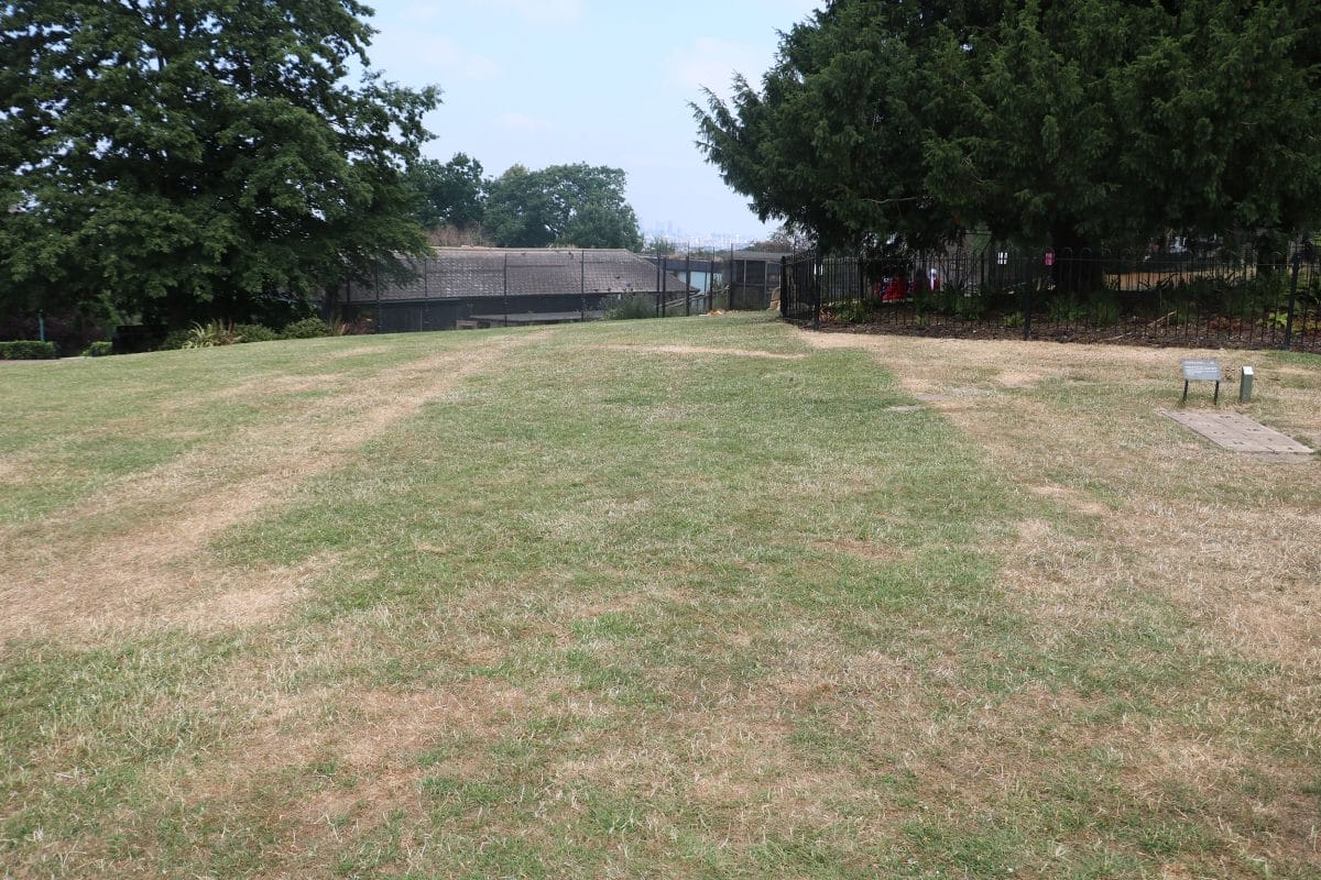 An outline of building foundations in the grass